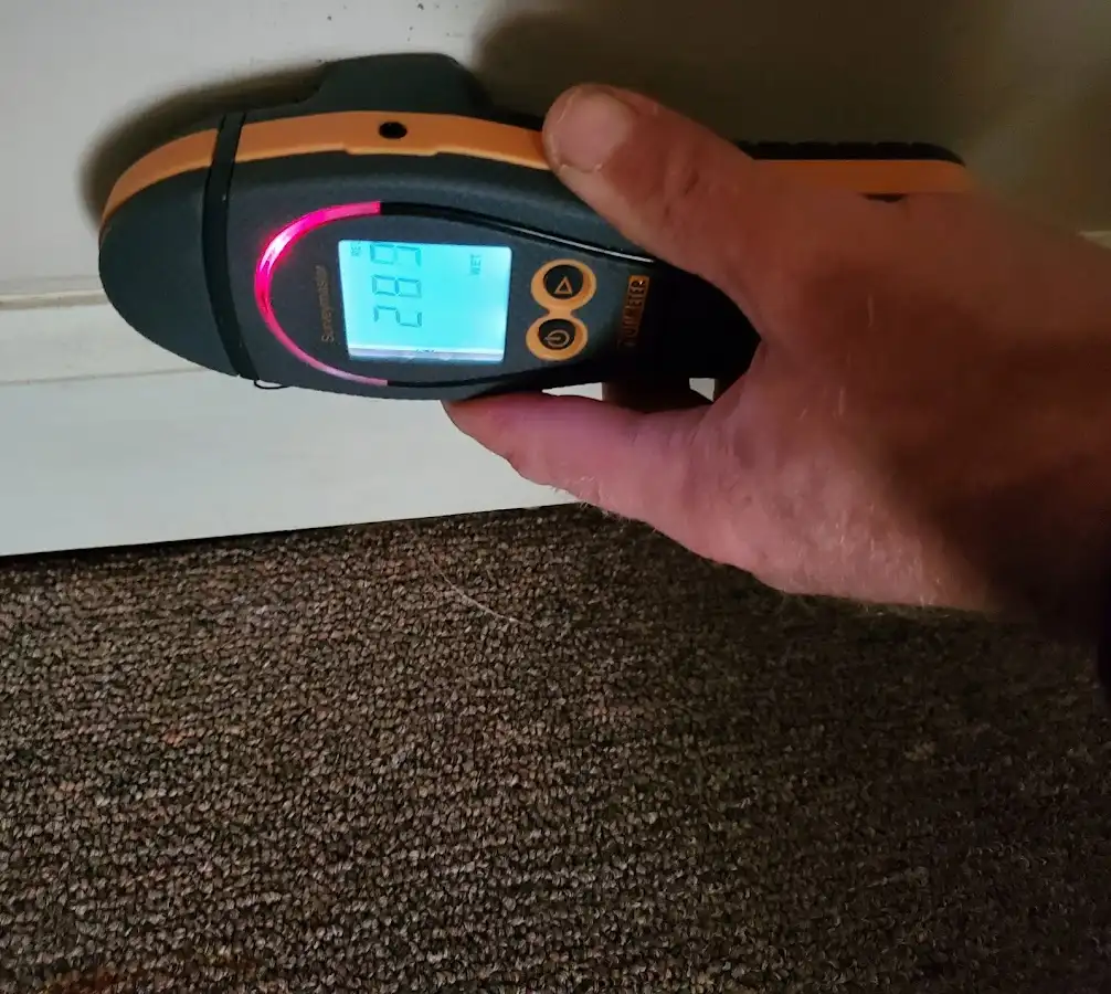 Moisture detection at baseboard during Storm Damage Restoration in Middlesex